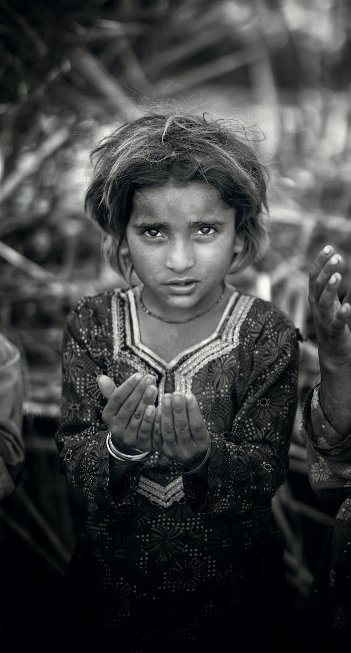A moving black and white portrait of a girl with an expressive gaze, conveying raw emotion.